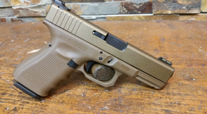 FDE Glock with Burnt Bronze slide, trigger guard has been bobbed and the finger groove raised.