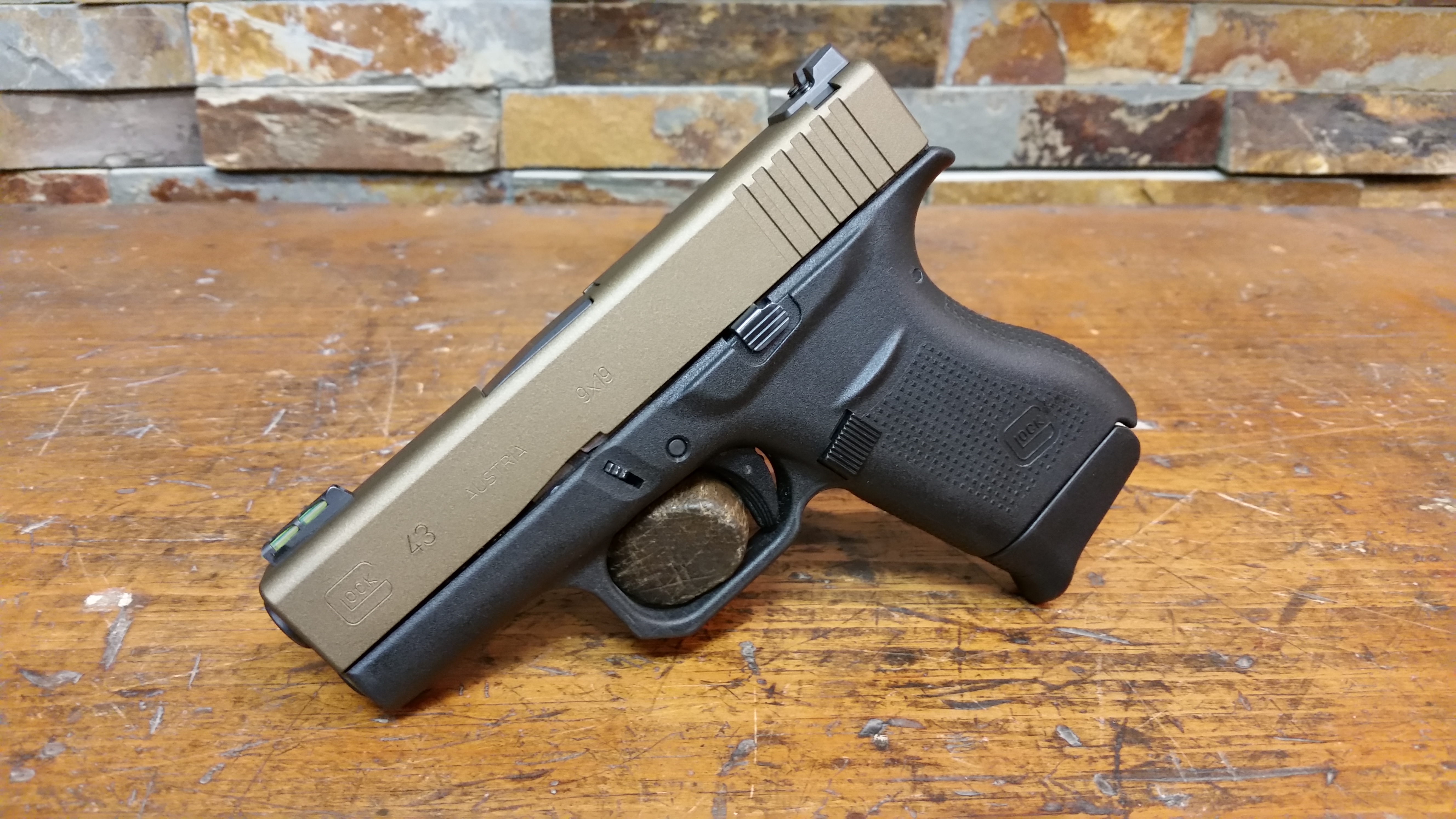 Glock G43 with Burnt Bronze slide, bobbed trigger guard and raised finger groove.  Typical cost on a project like this is $120.00 with turn around in about 7 days.